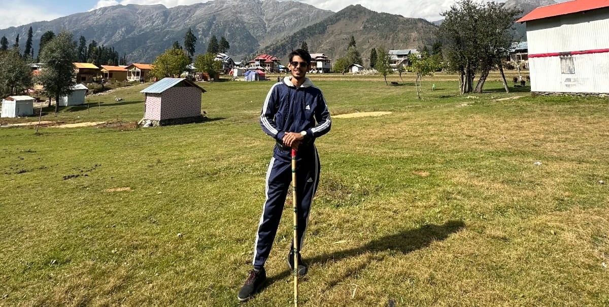 Abdullah standing in a green valley in northern Pakistan