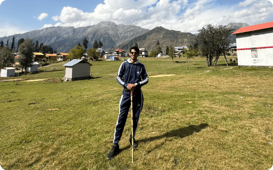 Abdullah standing in a green valley in northern Pakistan